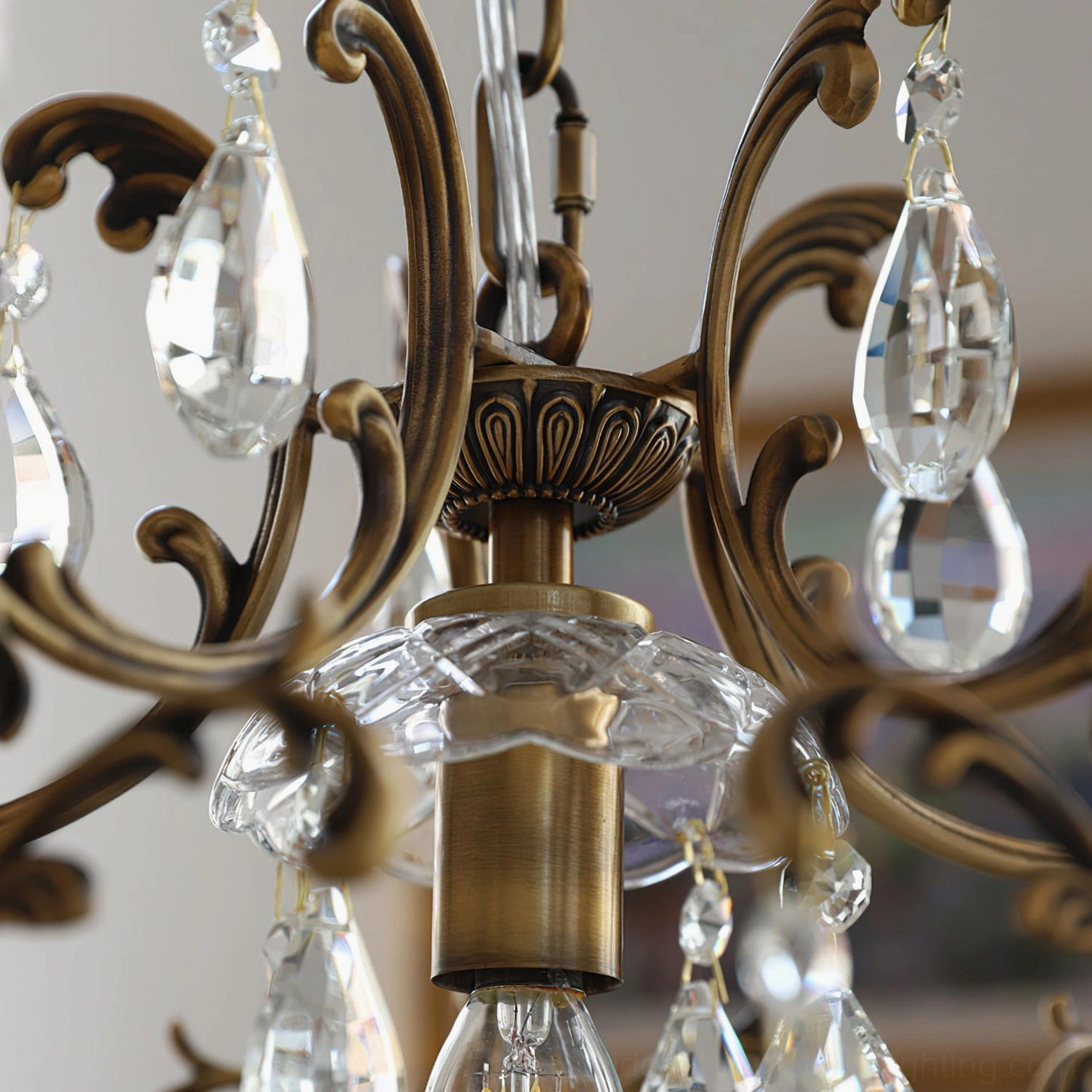 Close-up detail of bronze birdcage pendant scrollwork and clear glass crystal hardware craftsmanship