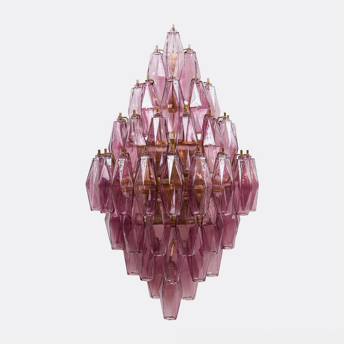 Polyhedral glass sconce showing multi-tiered prism arrangement and light diffusion