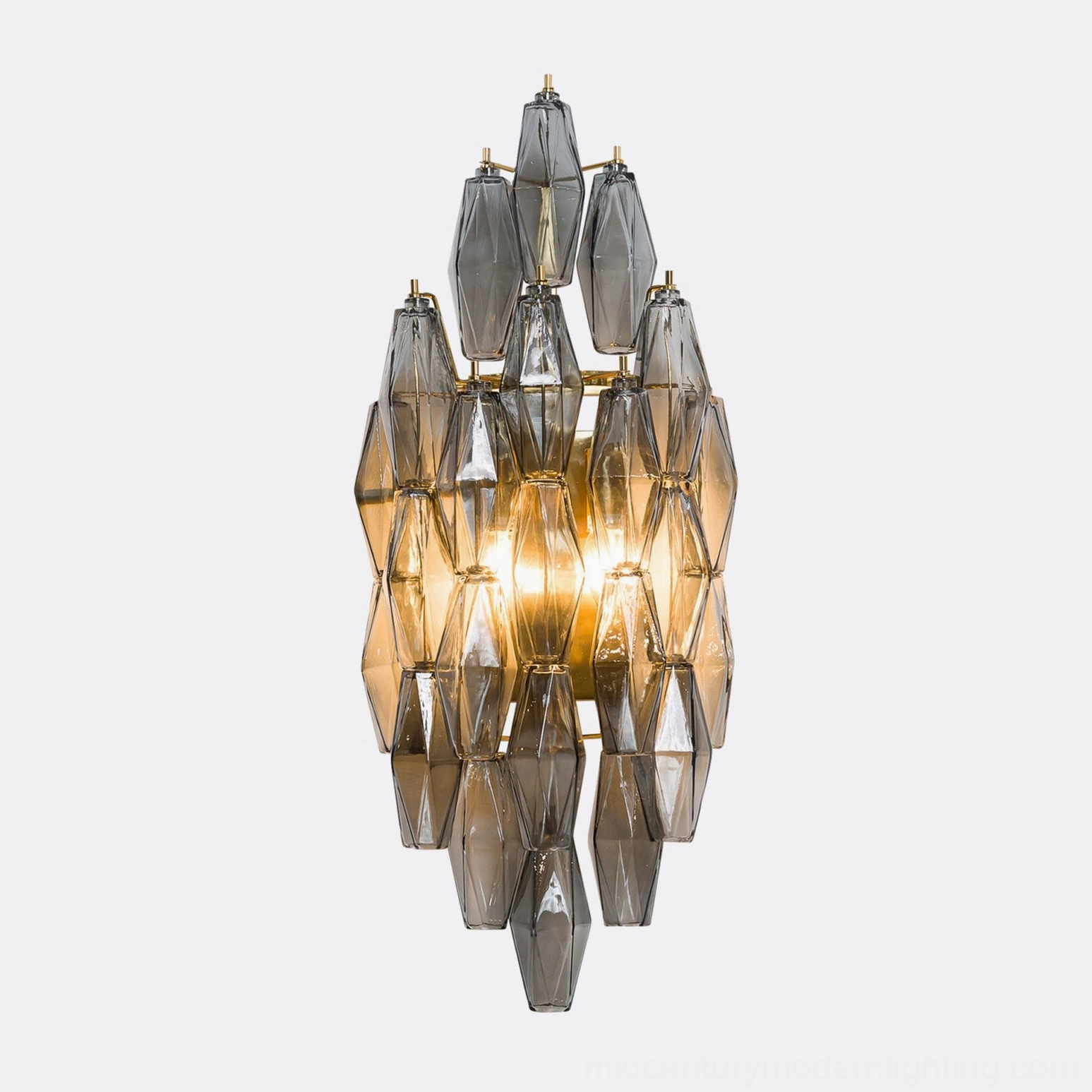 Wall-mounted polyhedral glass sconce showing glass suspension system and metal chassis connection