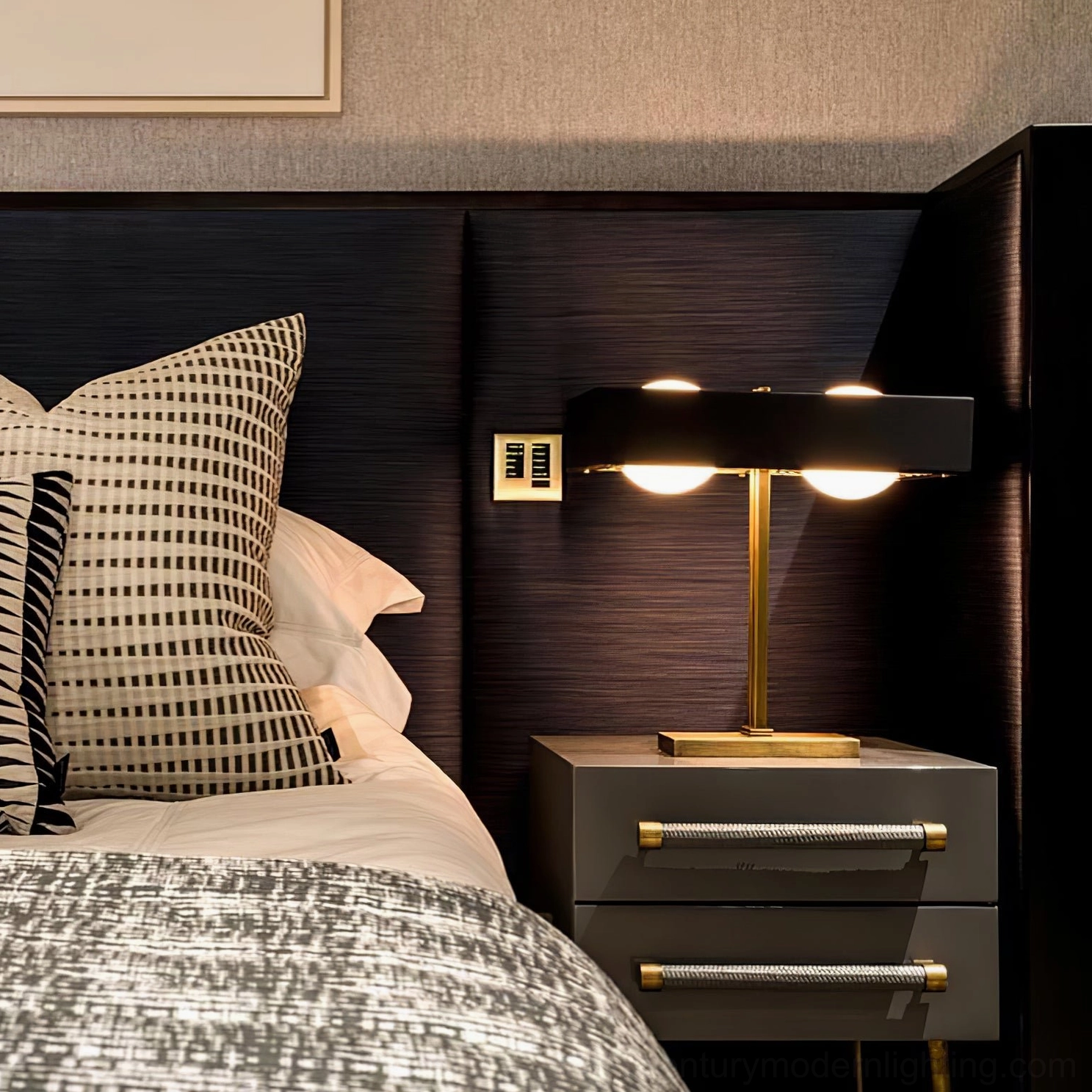 Black dual-bulb Kernel table lamp close-up with brass gold stand on dark grey nightstand