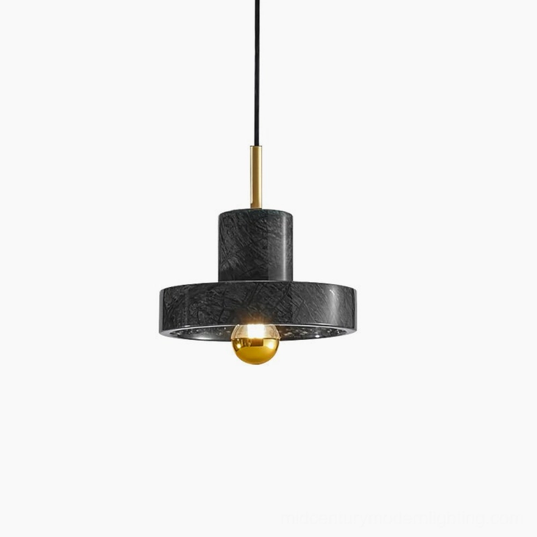 Black marble pendant lamp with brass fixture and warm LED bulb creating sophisticated ambient lighting