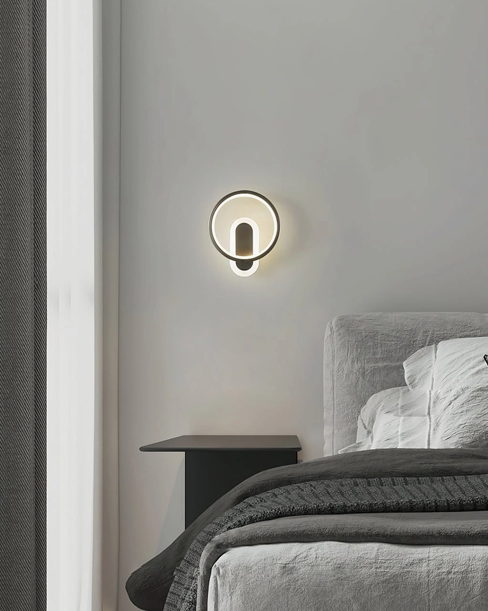 Mini round wall sconce matte black finish modern bedroom with grey bedding warm ambient light