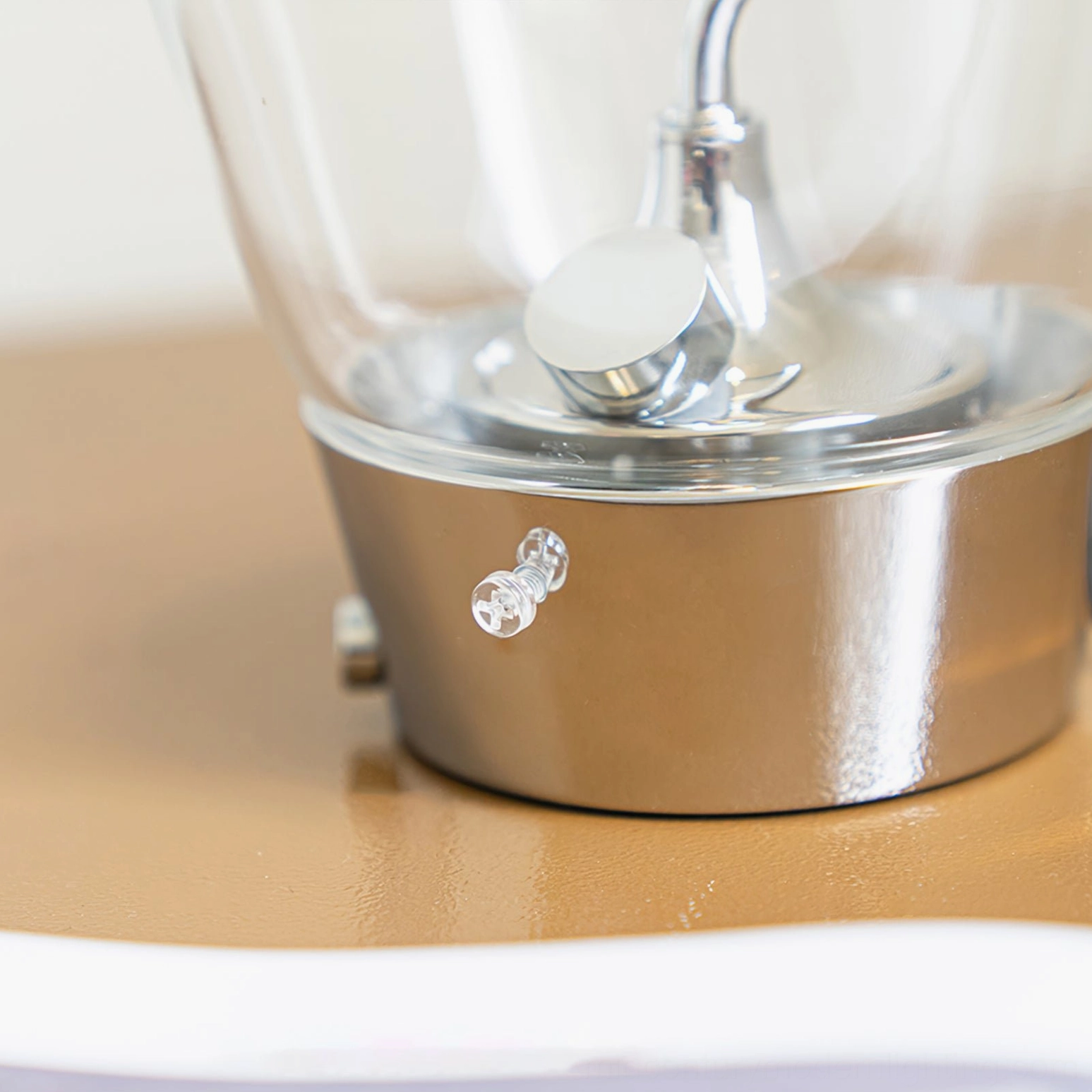 Blow lamp base close-up detail showing brushed chrome finish and decorative control knob