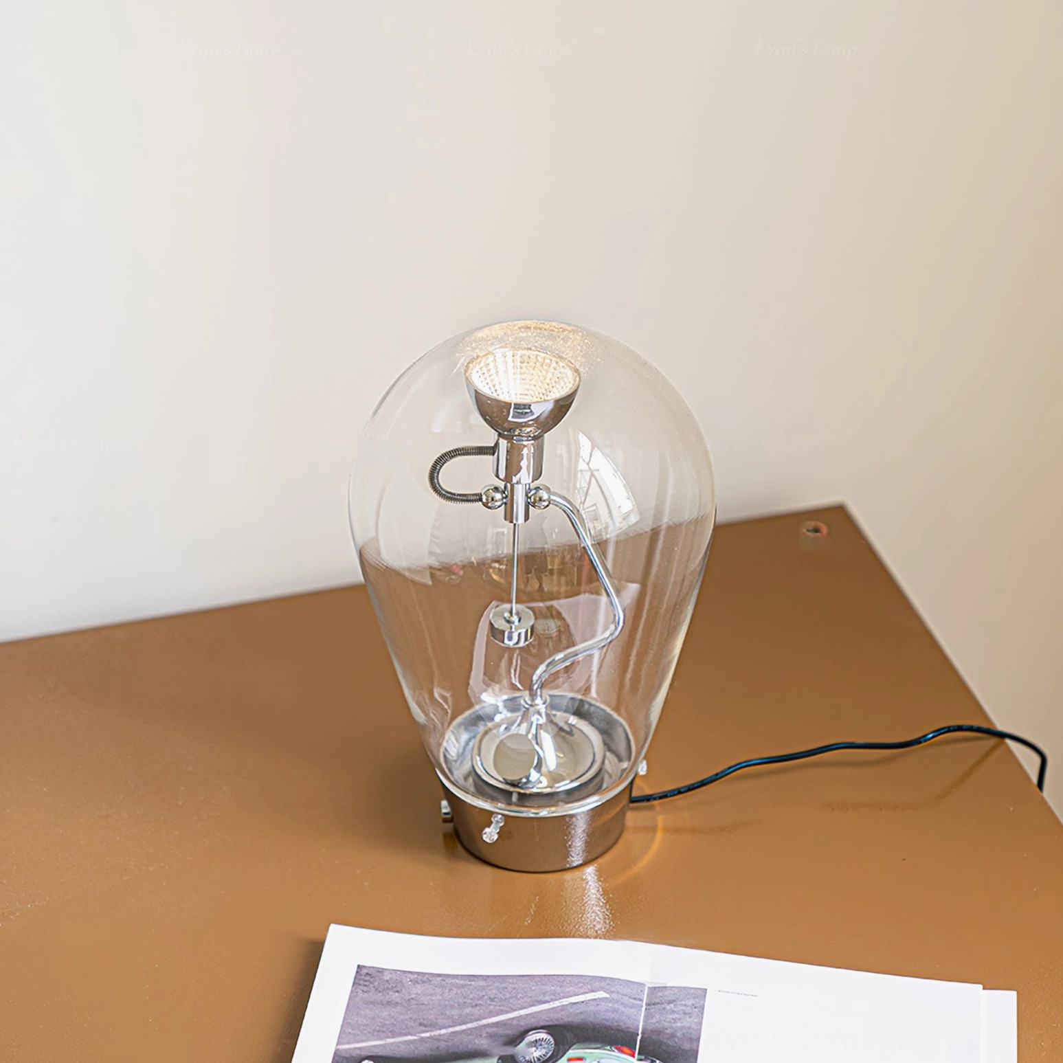 Blow table lamp low angle view illuminating desk surface with visible LED light source and chrome base