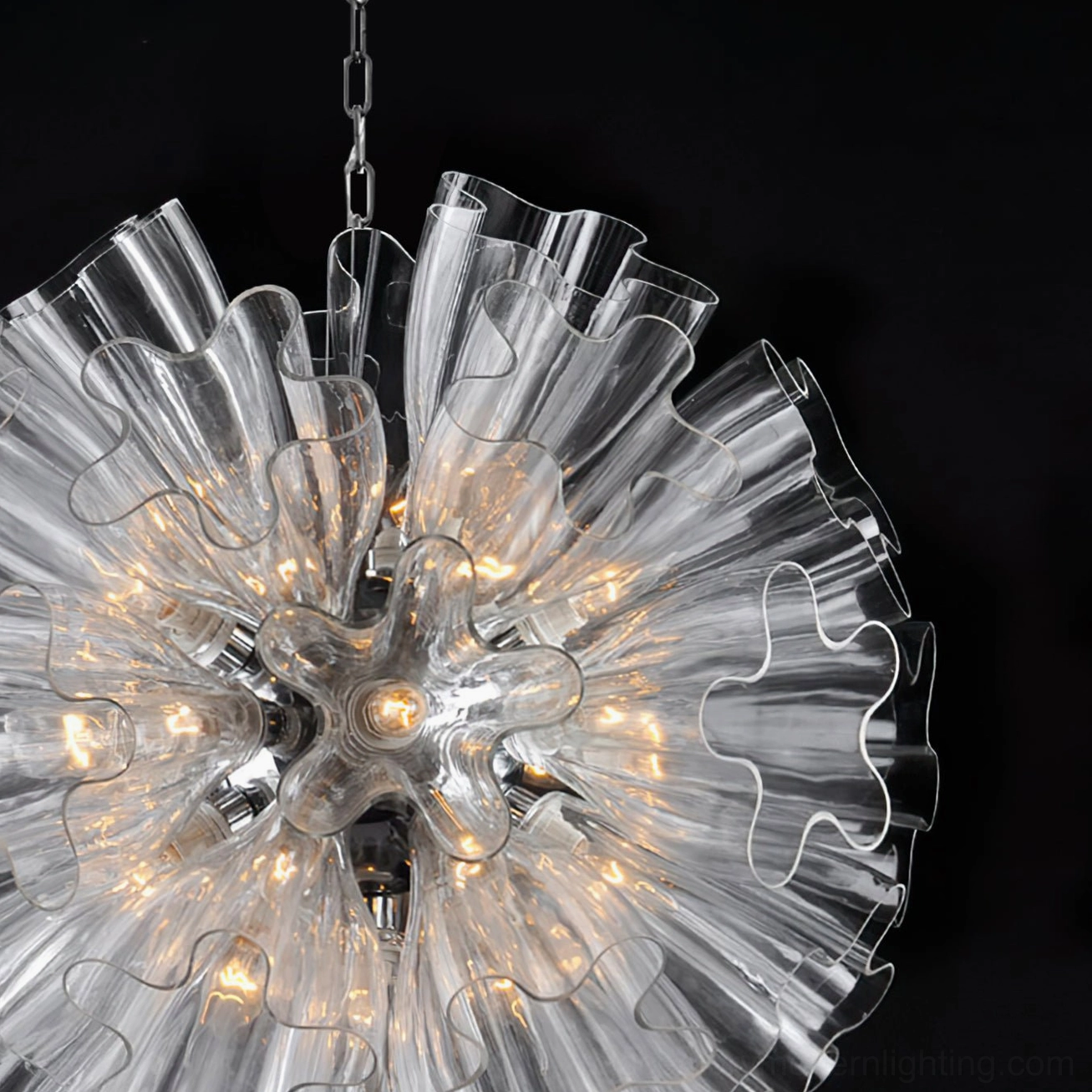 Close-up detail of Blum Chandelier showing warm LED bulbs and ruffled glass texture