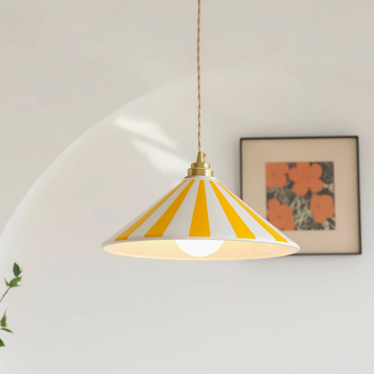 Yellow and white striped Bobine pendant light hanging at eye level in minimalist interior with floral artwork