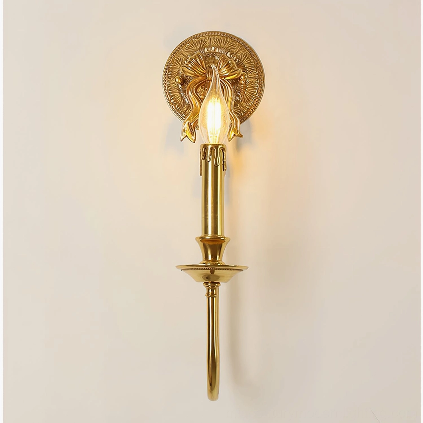 Bow brass wall sconce front view against neutral background showing neoclassical design