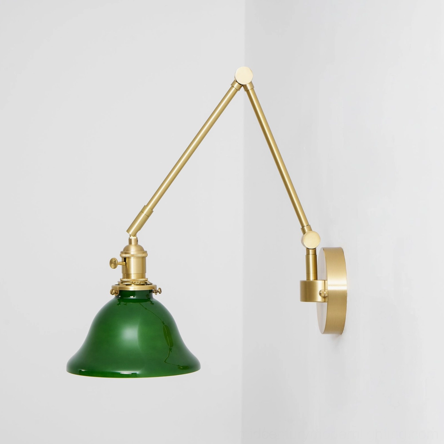 Brady swing arm wall lamp industrial workspace showing honest brass and mechanical design