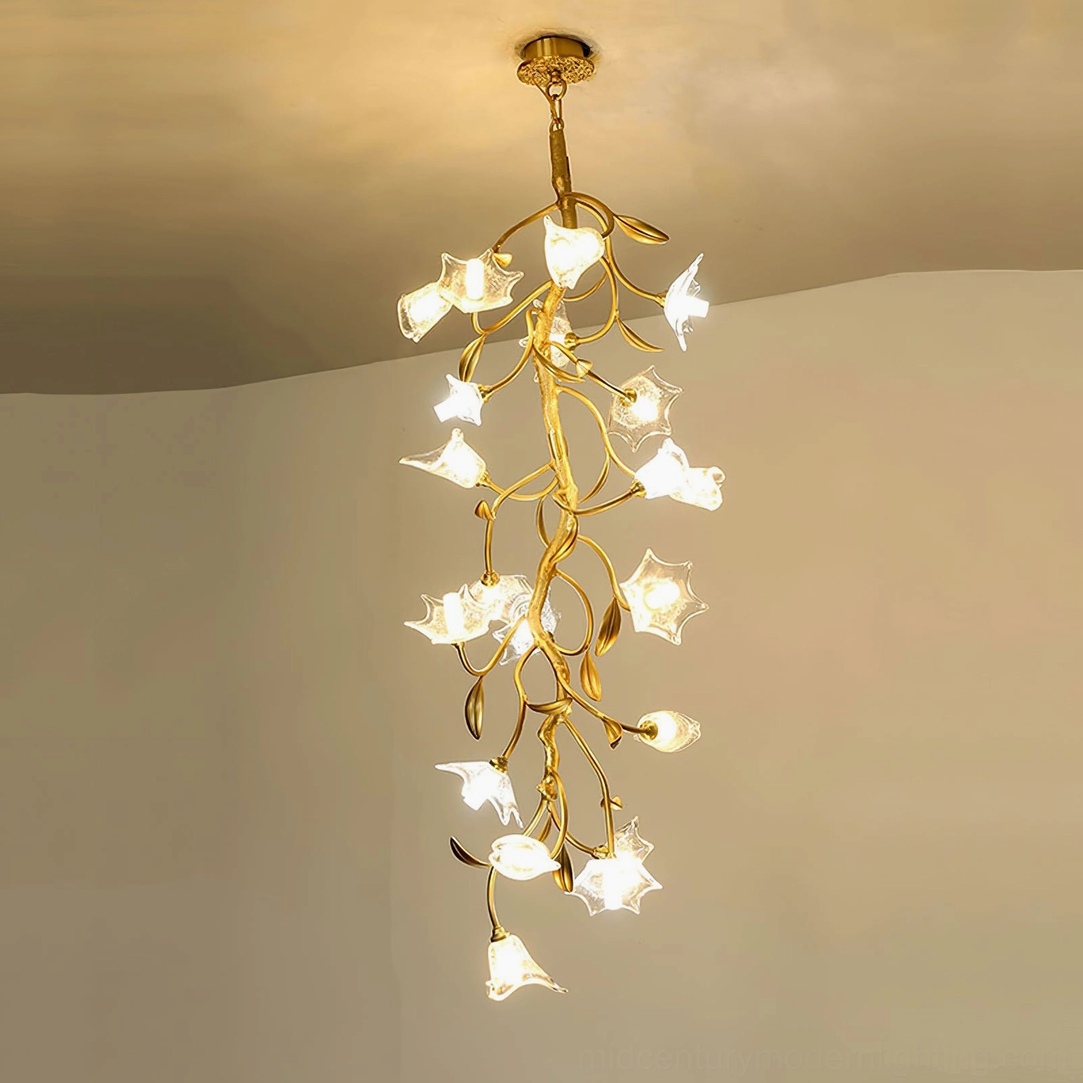 Branch floral chandelier with glowing glass flower-shaped lamps and warm recessed lighting in residential interior