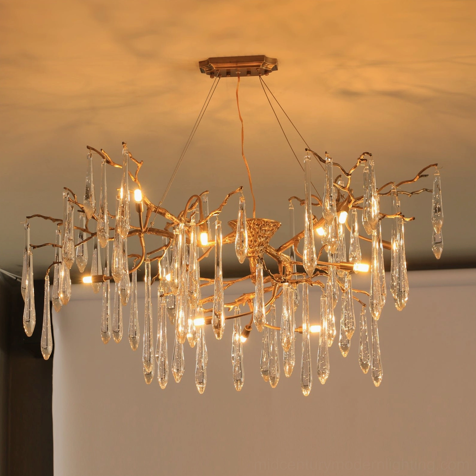 Branch Raindrop Crystal Chandelier installed overhead with warm ambient lighting, displaying bronze brass branches and faceted glass crystals
