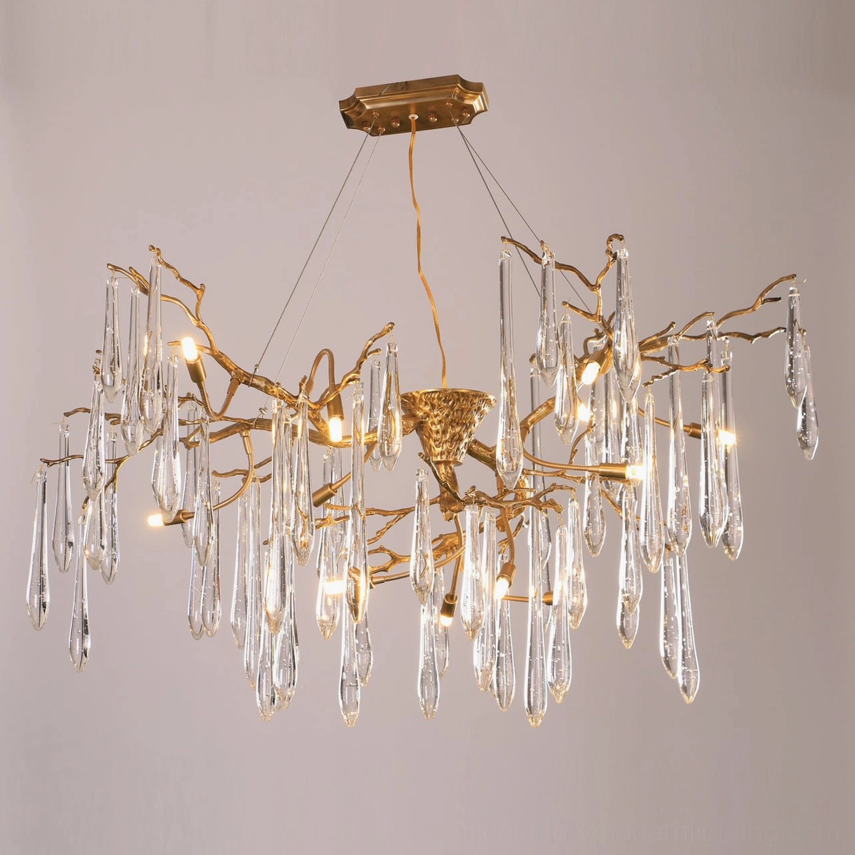 Partially illuminated Branch Raindrop Chandelier overhead view with natural branch metal structure, clear crystals, and artistic light distribution