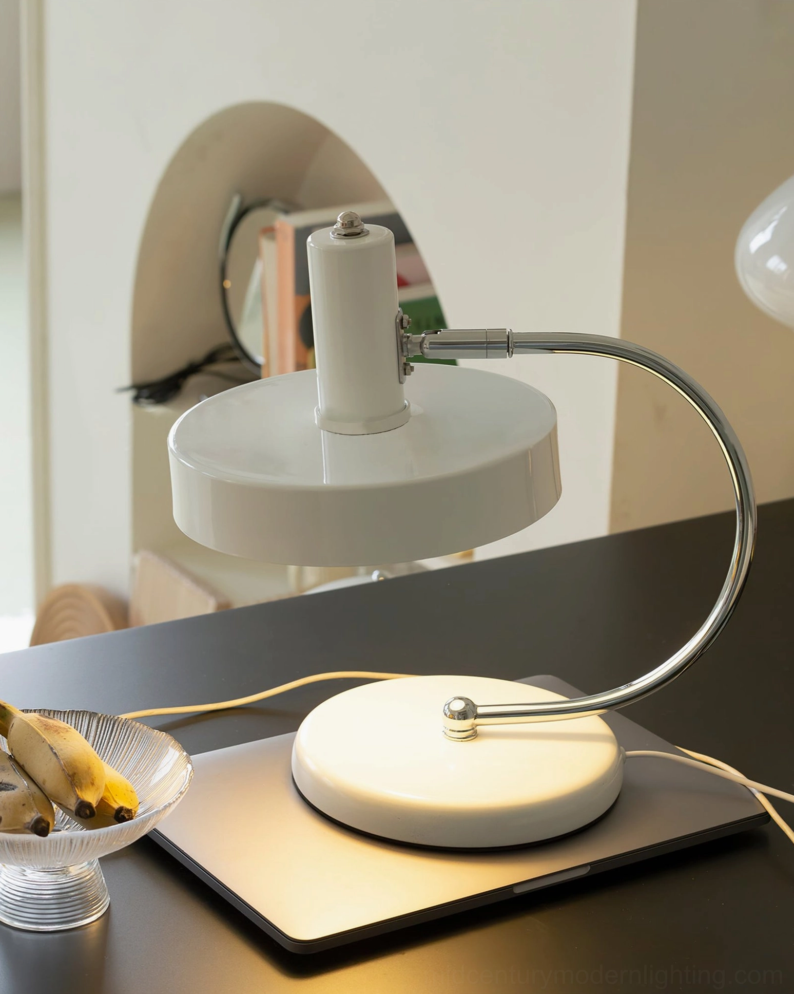 Modern Brano white desk lamp in dark home office with decorative bowl, mood lighting