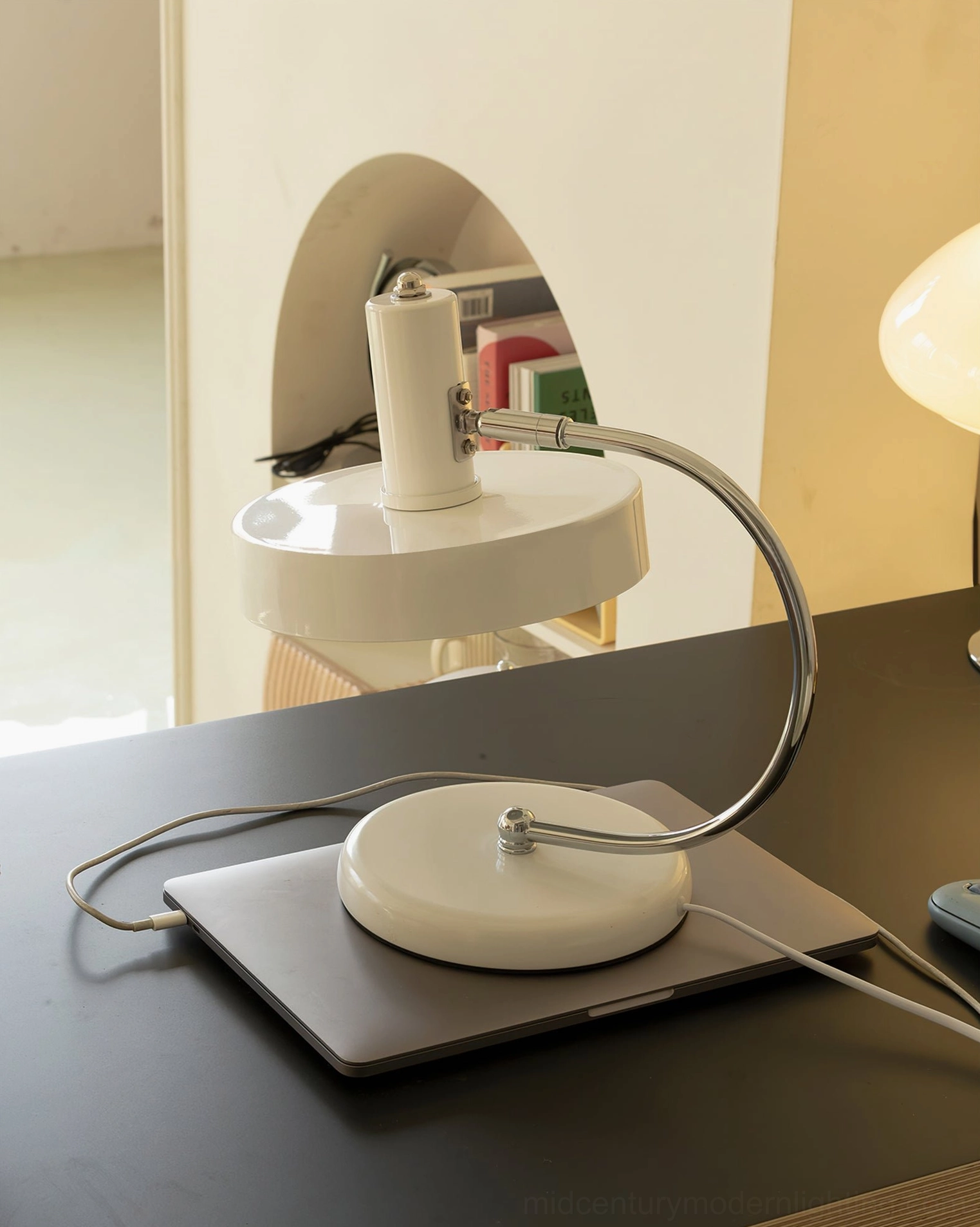 Brano minimalist table lamp on laptop charging pad, contemporary tech workspace styling