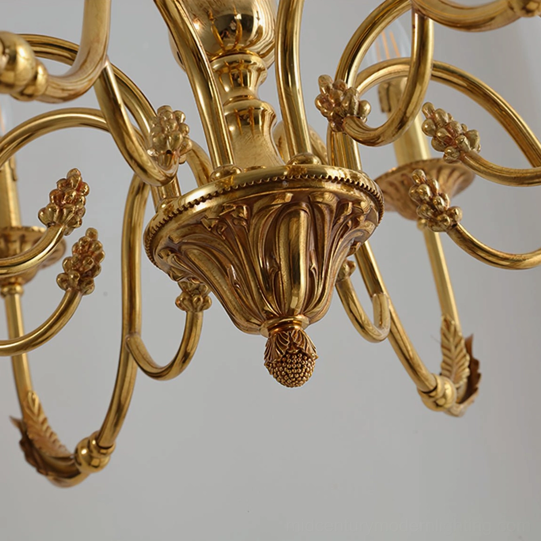 Overhead view of ornate brass candle chandelier canopy with decorative drop finial