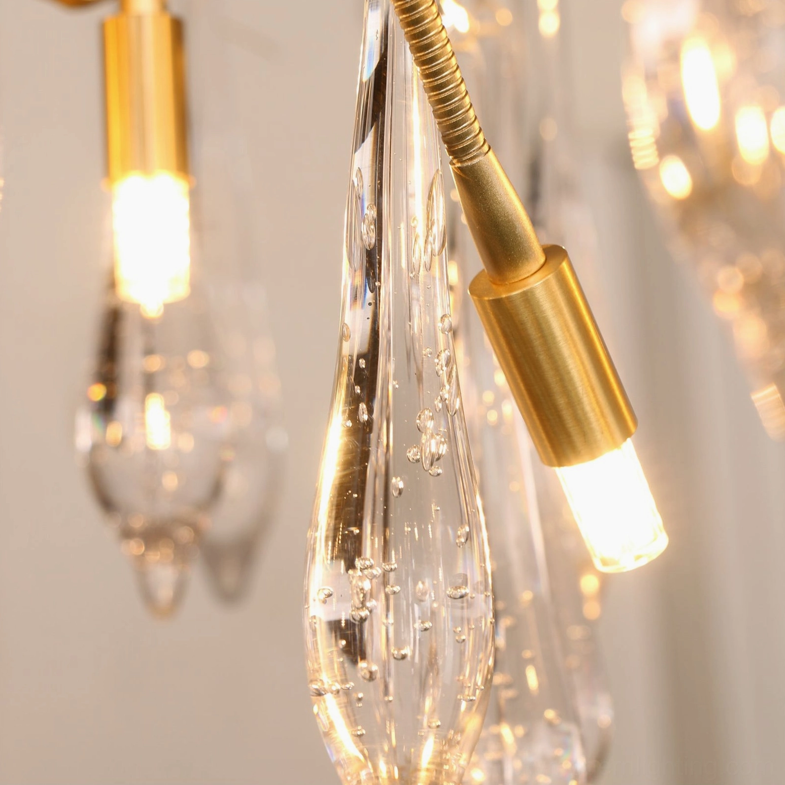Brass G9 lamp socket with bubble-textured water-drop shaped clear glass pendant close-up