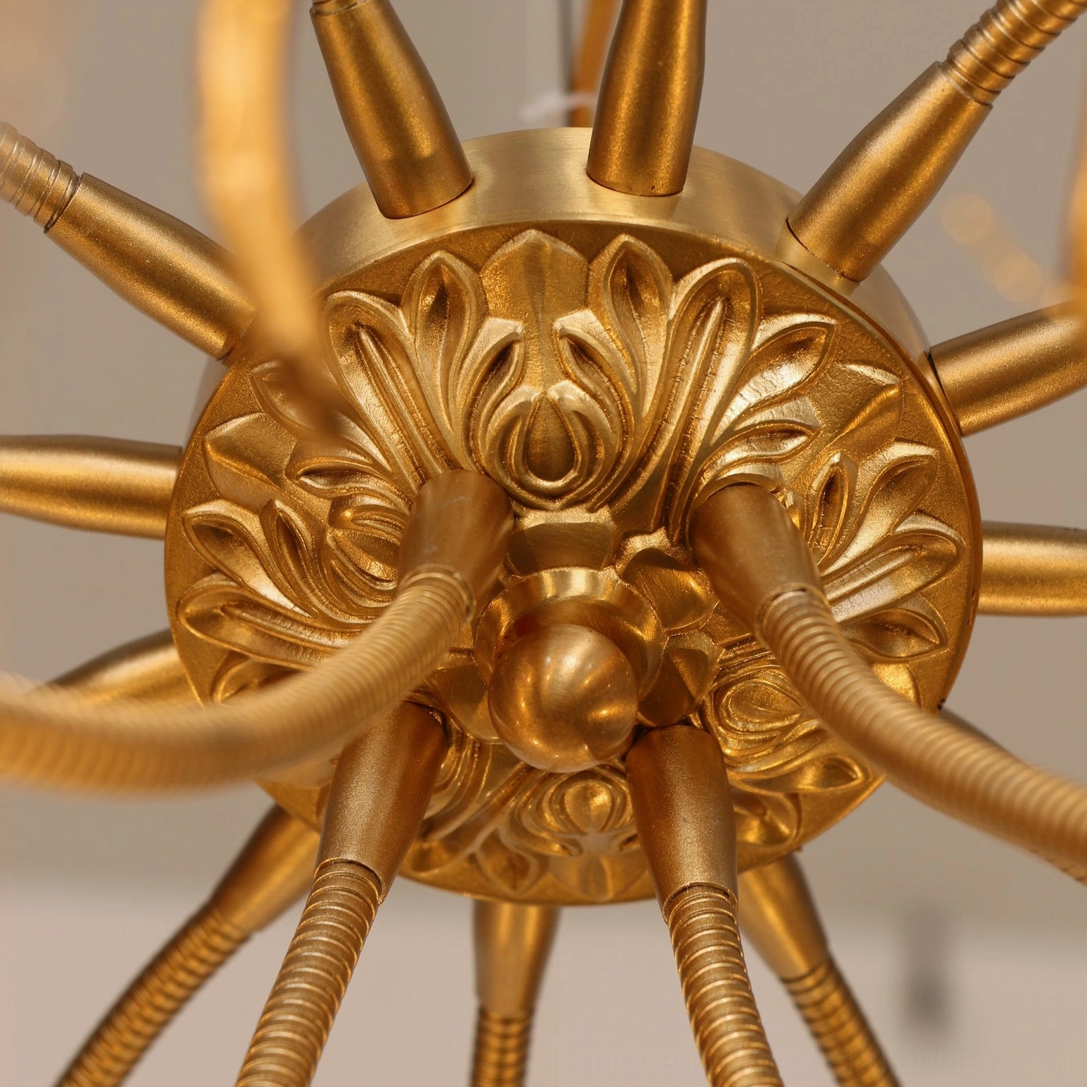 Baroque carved brass chandelier internal metal framework overhead radial branch structure
