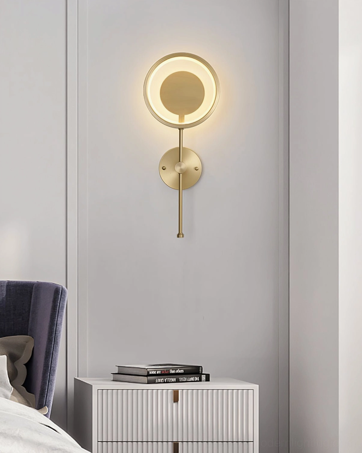 Polished brass finish LED ring wall lamp in contemporary interior creating warm metallic glow