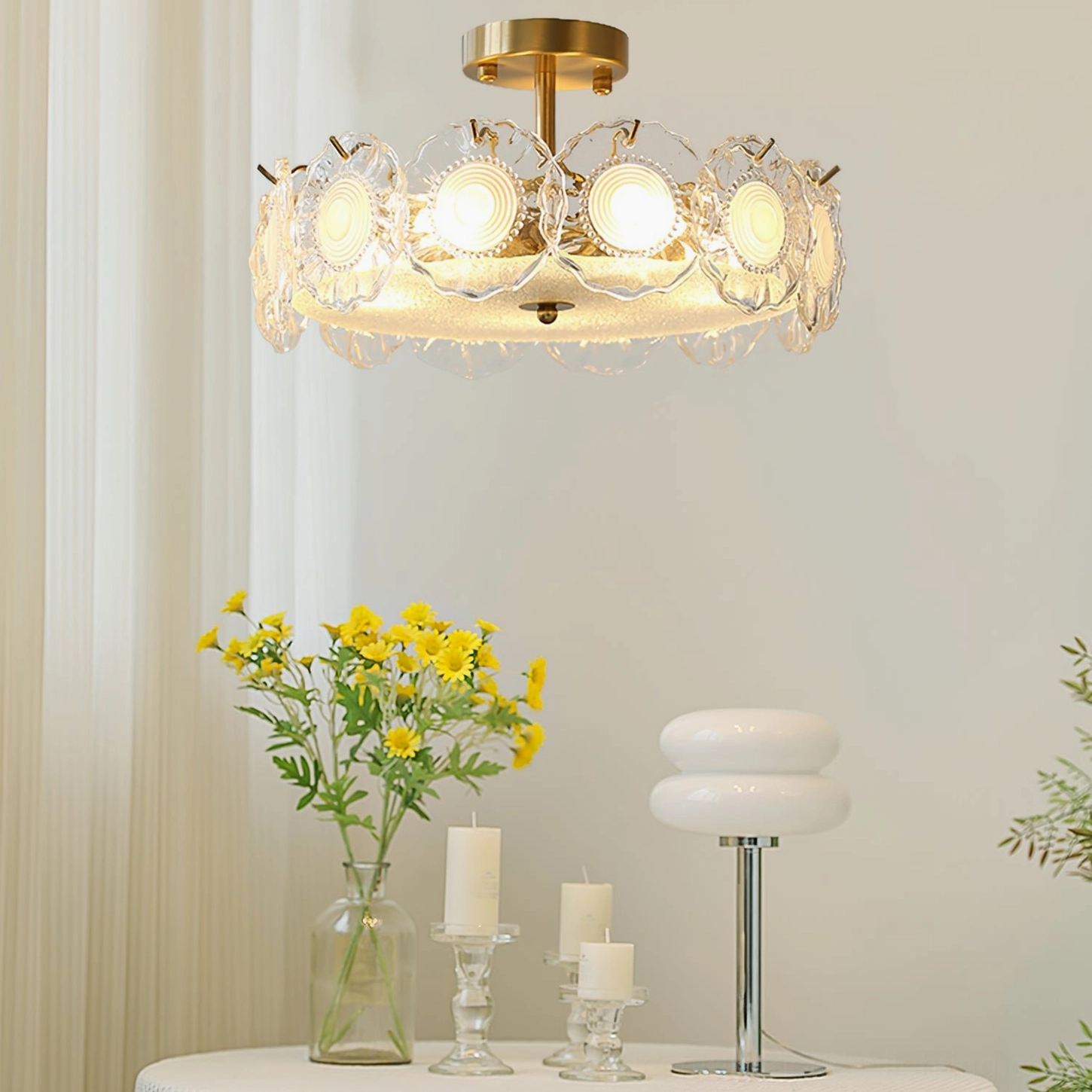Elegant brass ceiling lamp illuminated in cozy home setting with flowers, candles and warm vintage decor