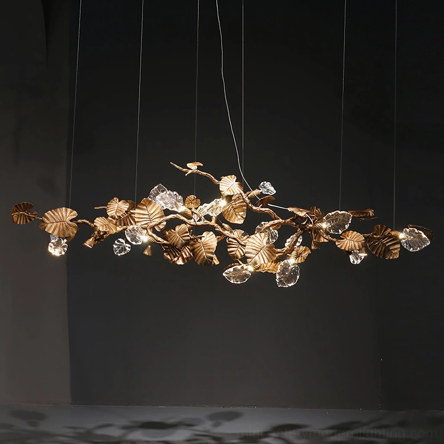 Brass leaf chandelier architectural view - geometric arrangement of illuminated glass leaves on studio backdrop