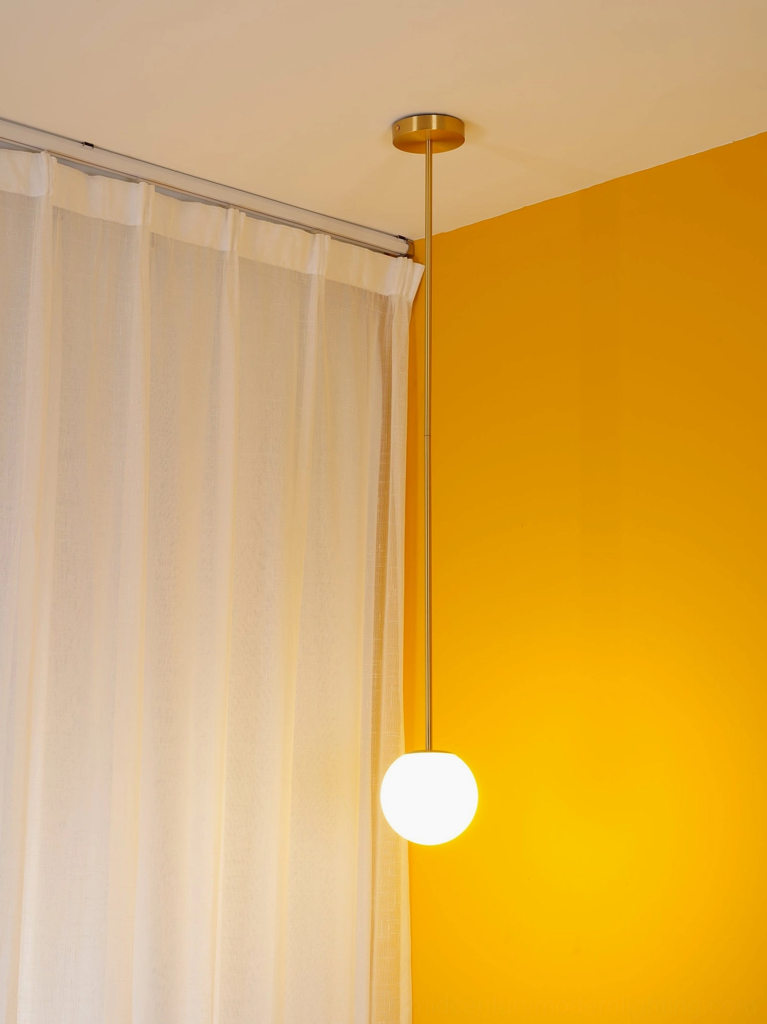 Brass pendant light fixture installed at various heights showing design versatility