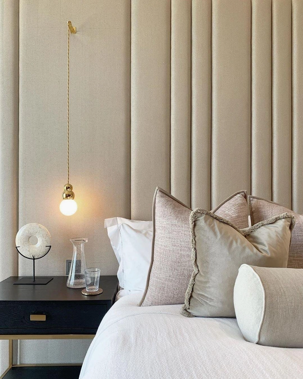 Brass spherical wall pendant in luxury master bedroom, warm ambient lighting, bedside wall sconce
