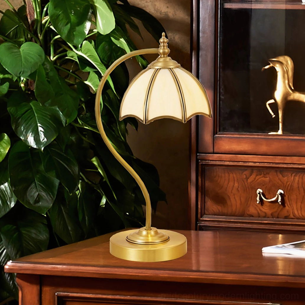 Brass umbrella lamp as decorative accent piece on vintage wooden display with potted plant