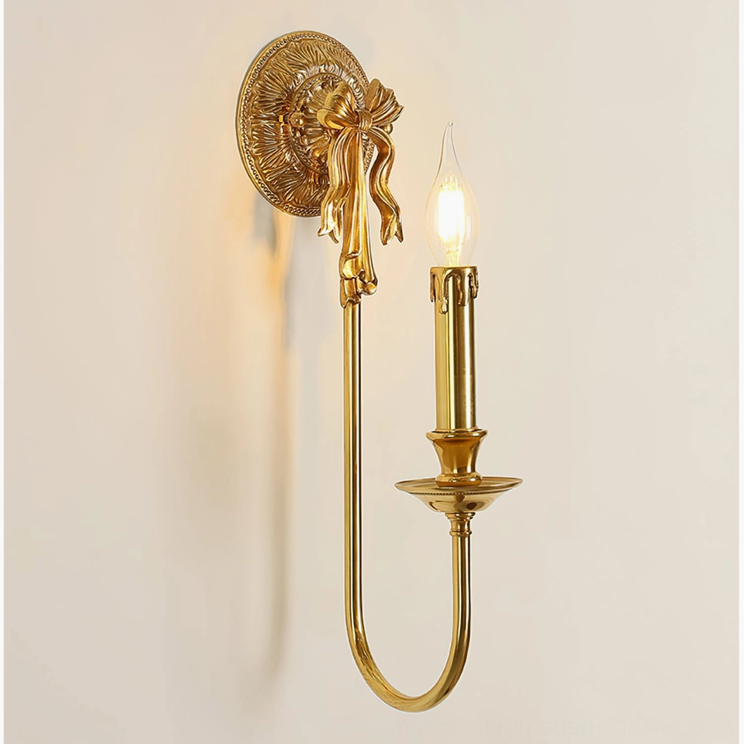 Oblique angle of single-arm brass wall lamp with curved bow-shaped base