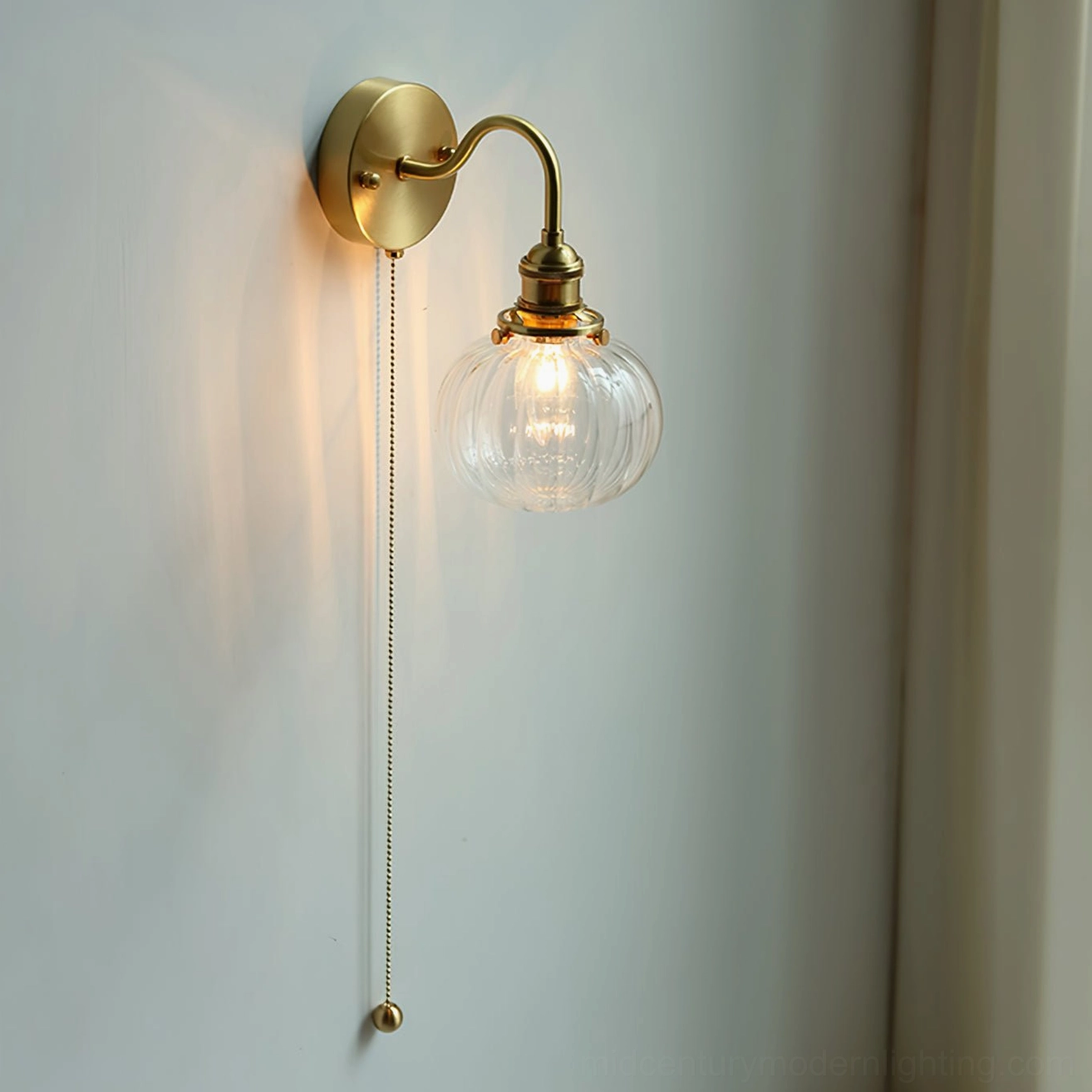 Multiple color finishes of mid-century brass wall sconce - clear, smoke gray, and blue glass options