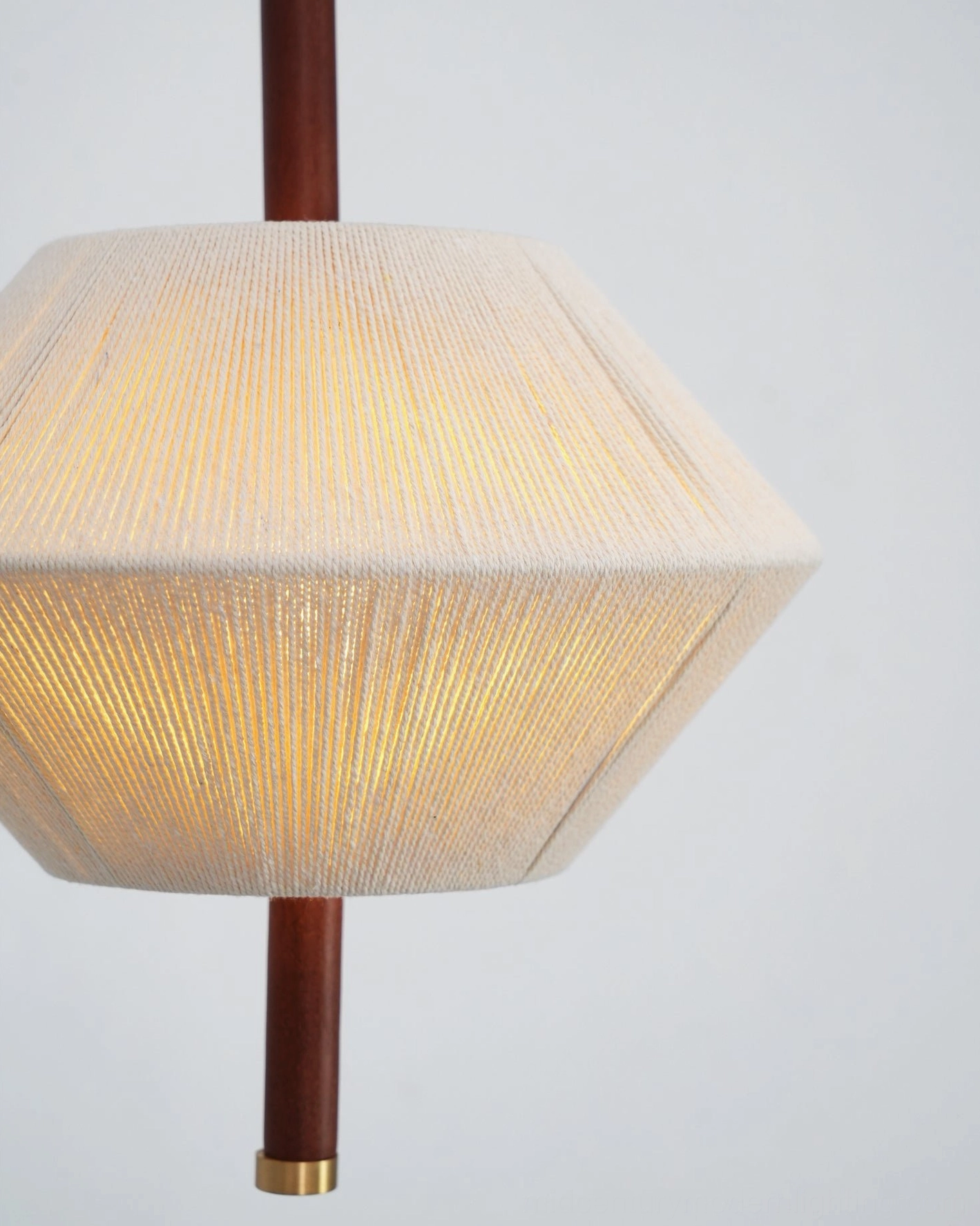 Brera pendant light creating warm ambient lighting in mid-century modern styled dining or living area