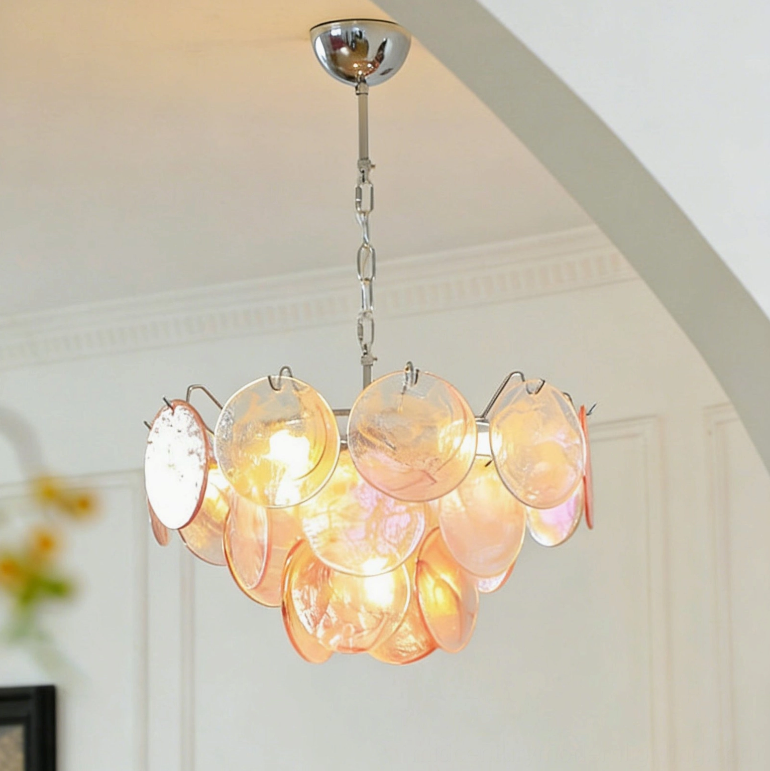 Brette amber gradient disk chandelier in arched doorway modern room creating warm glowing three-quarter front view