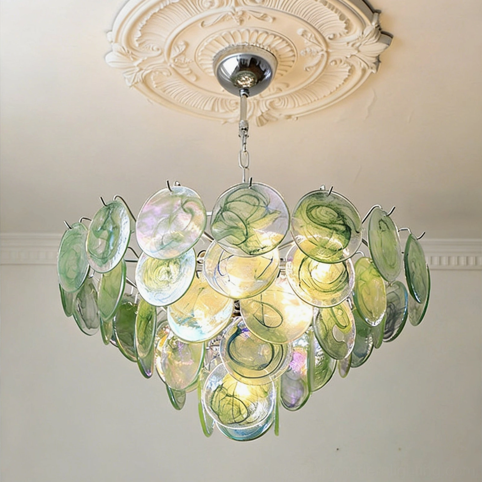Brette disk chandelier detail showing water-ripple texture etching on iridescent glass discs for light diffusion