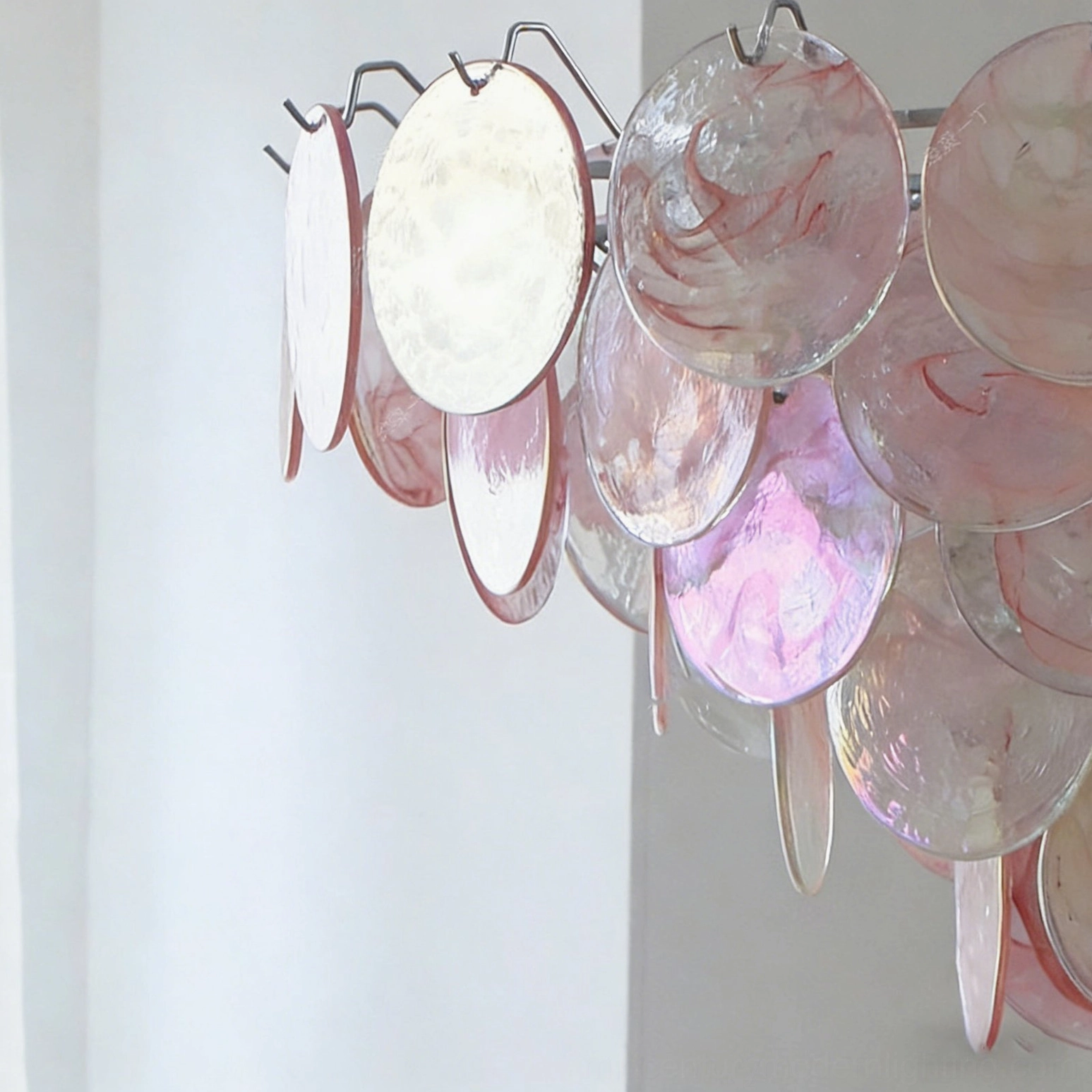 Brette iridescent glass chandelier fixture detail showing polished chrome metal suspension and glass disc arrangement