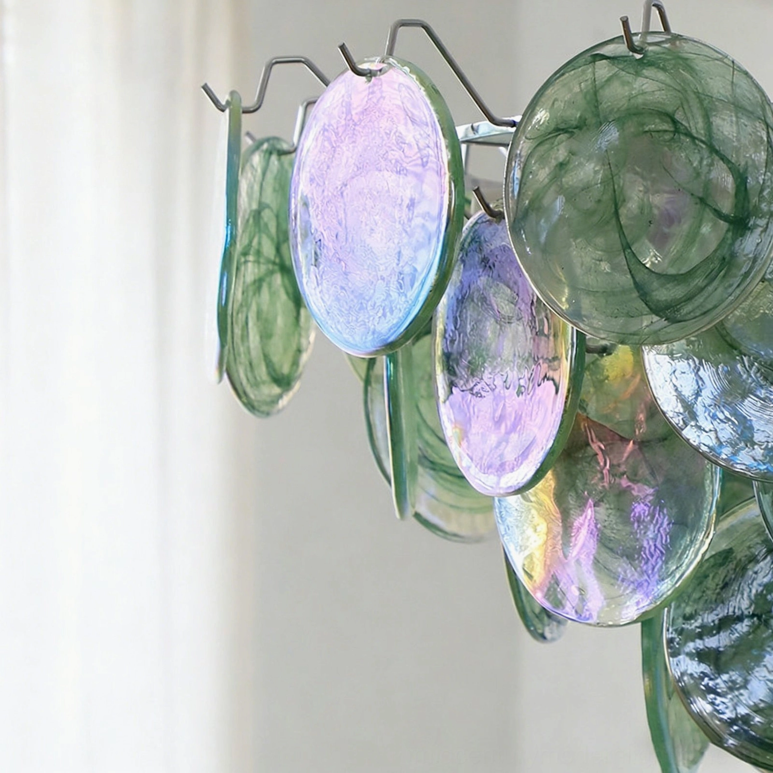 Brette marbled glass chandelier components close-up showing green and purple iridescent glass disc details