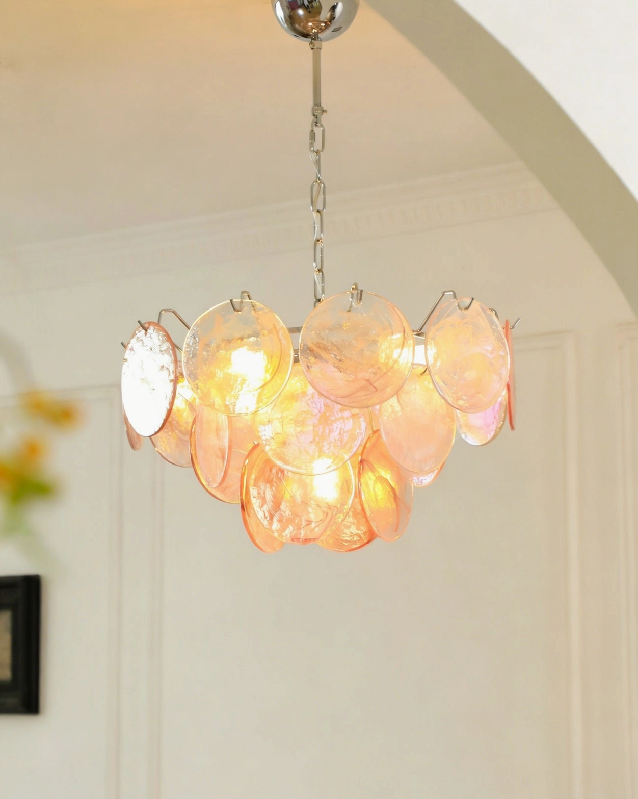 Brette warm amber disc chandelier side view with polished chrome suspension chain in white arched interior space