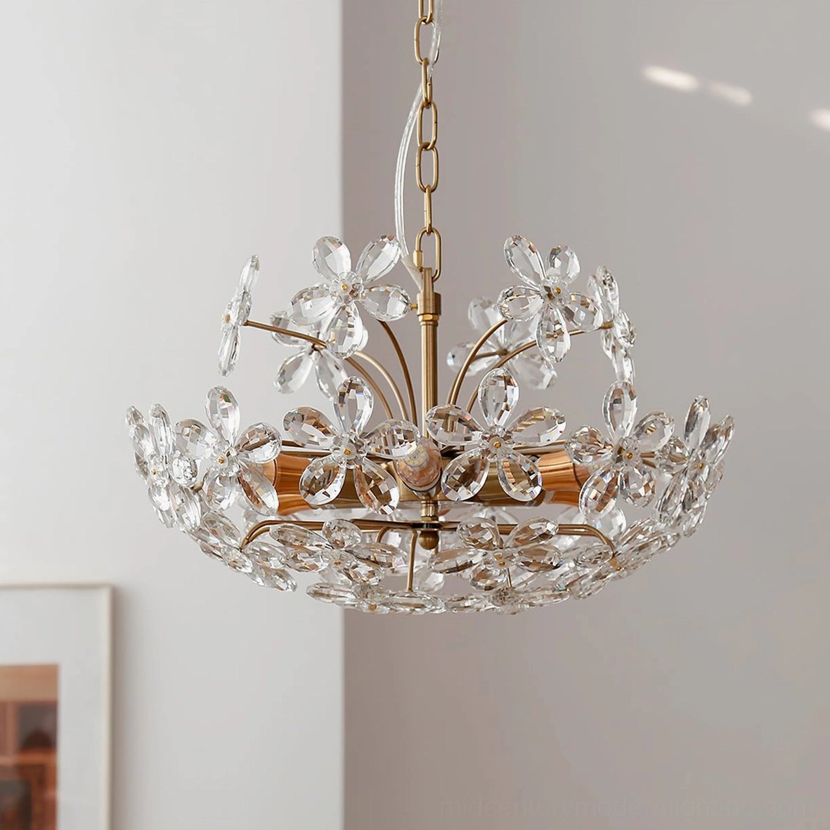 Silver-toned floral crystal chandelier in minimalist white studio with wall art, sleek elegant romantic design