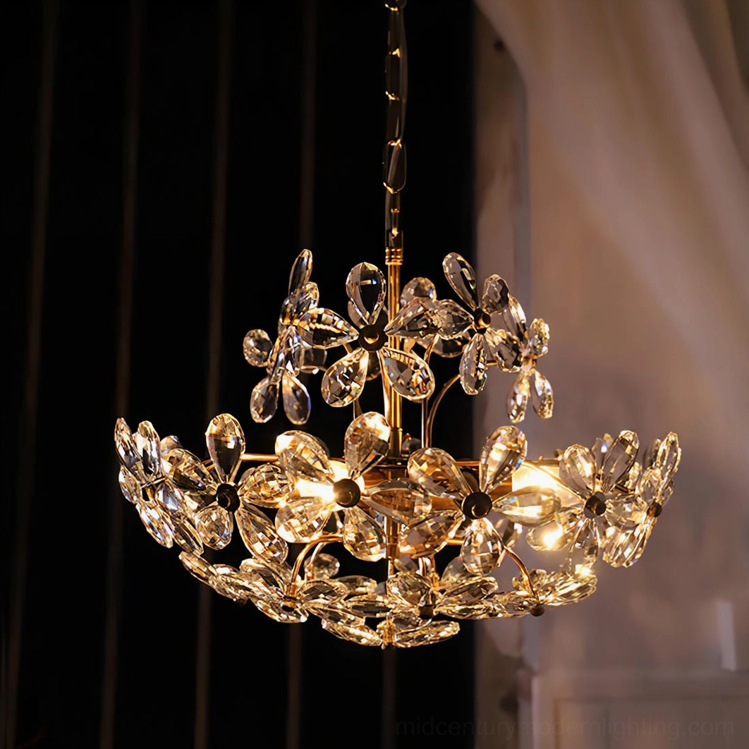 Dark gold floral crystal chandelier with low side view against dark curtain backdrop, vintage glamorous setting