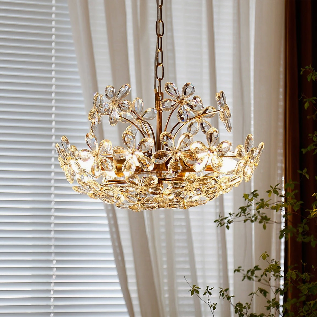 Side front view of elegant floral crystal chandelier near window with blinds and sheer curtains, French country style