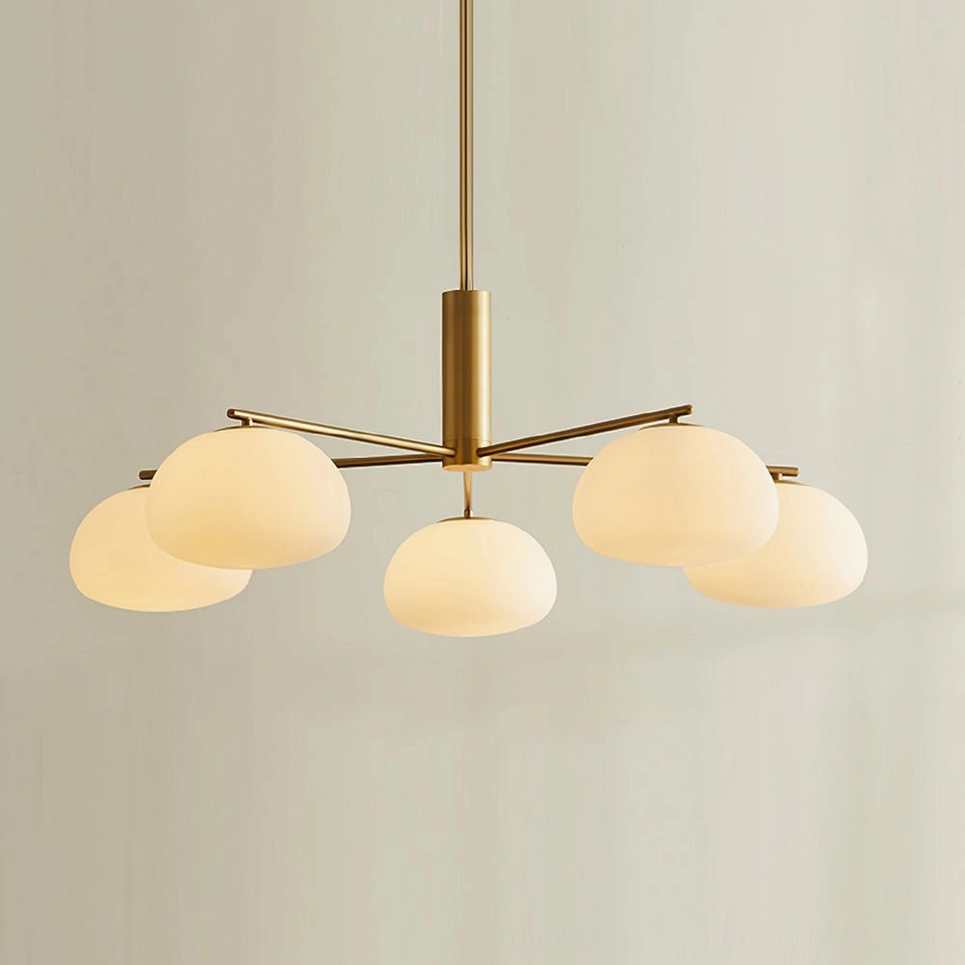 Brass sputnik Briette chandelier direct front view with warm brass finish and glowing round opal glass shades on neutral background
