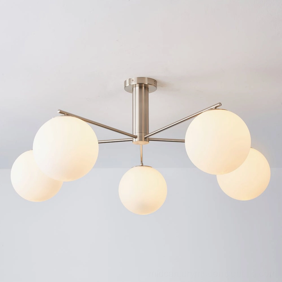 Briette chrome sputnik ceiling fixture illuminated showing frosted opal glass shades with bright light output - front view