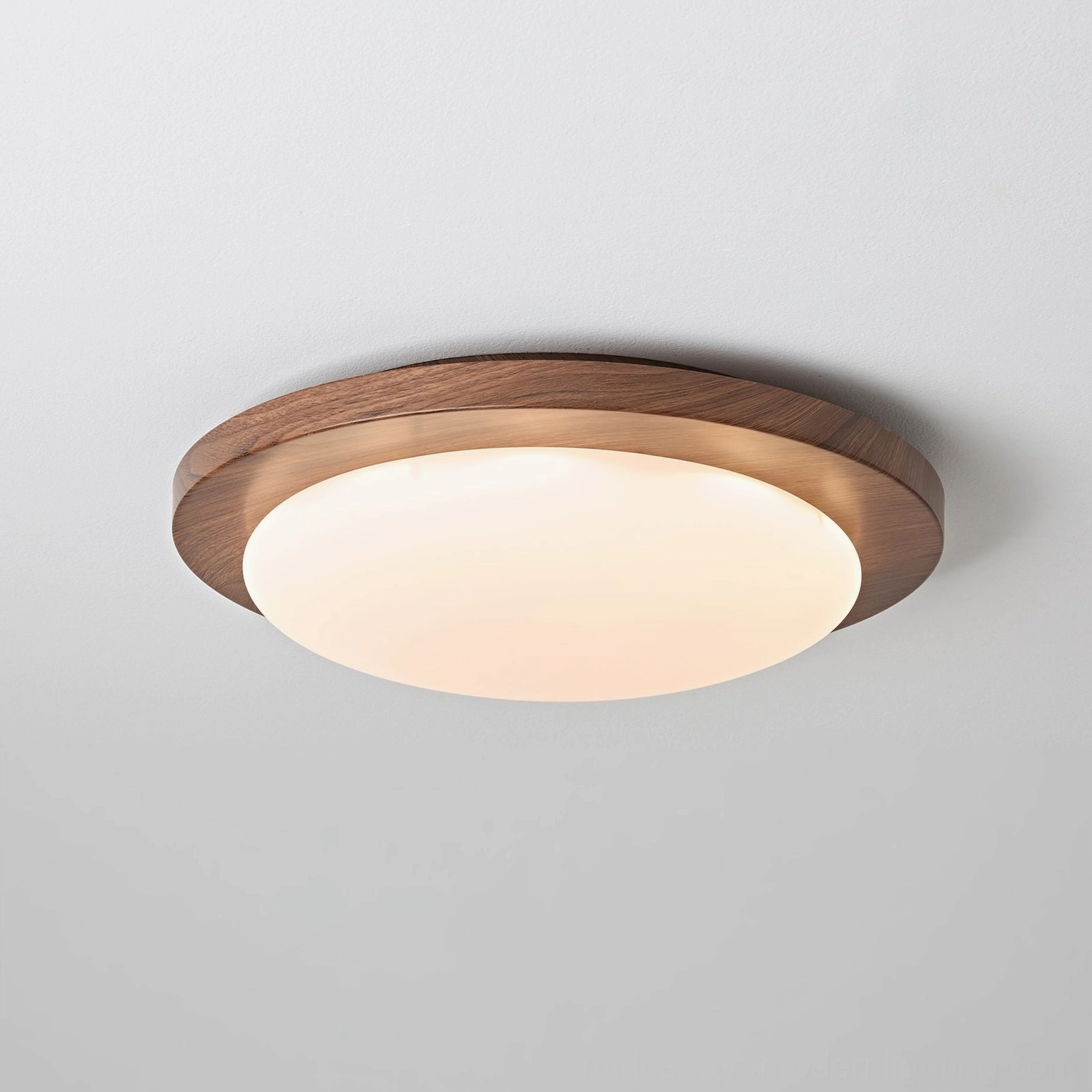 Front-facing view of Bromo ceiling light illuminated, showcasing warm white LED glow and walnut wood border