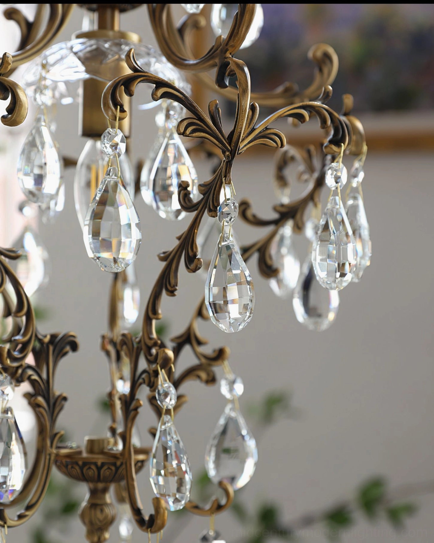 Bronze birdcage pendant light with refined scrollwork design and crystal light refraction details