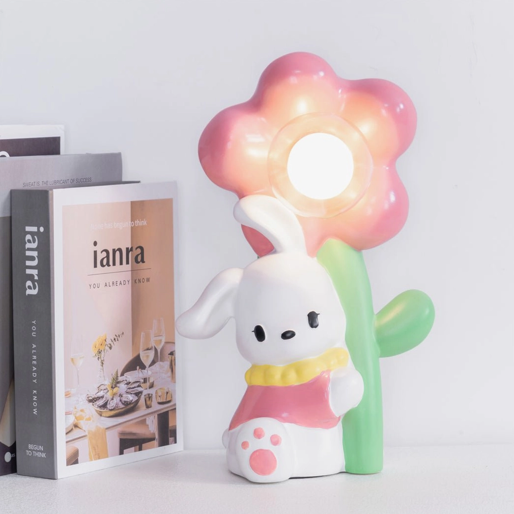 Glowing pink Bunny Flower Table Lamp on bookshelf creating warm ambient light in home setting
