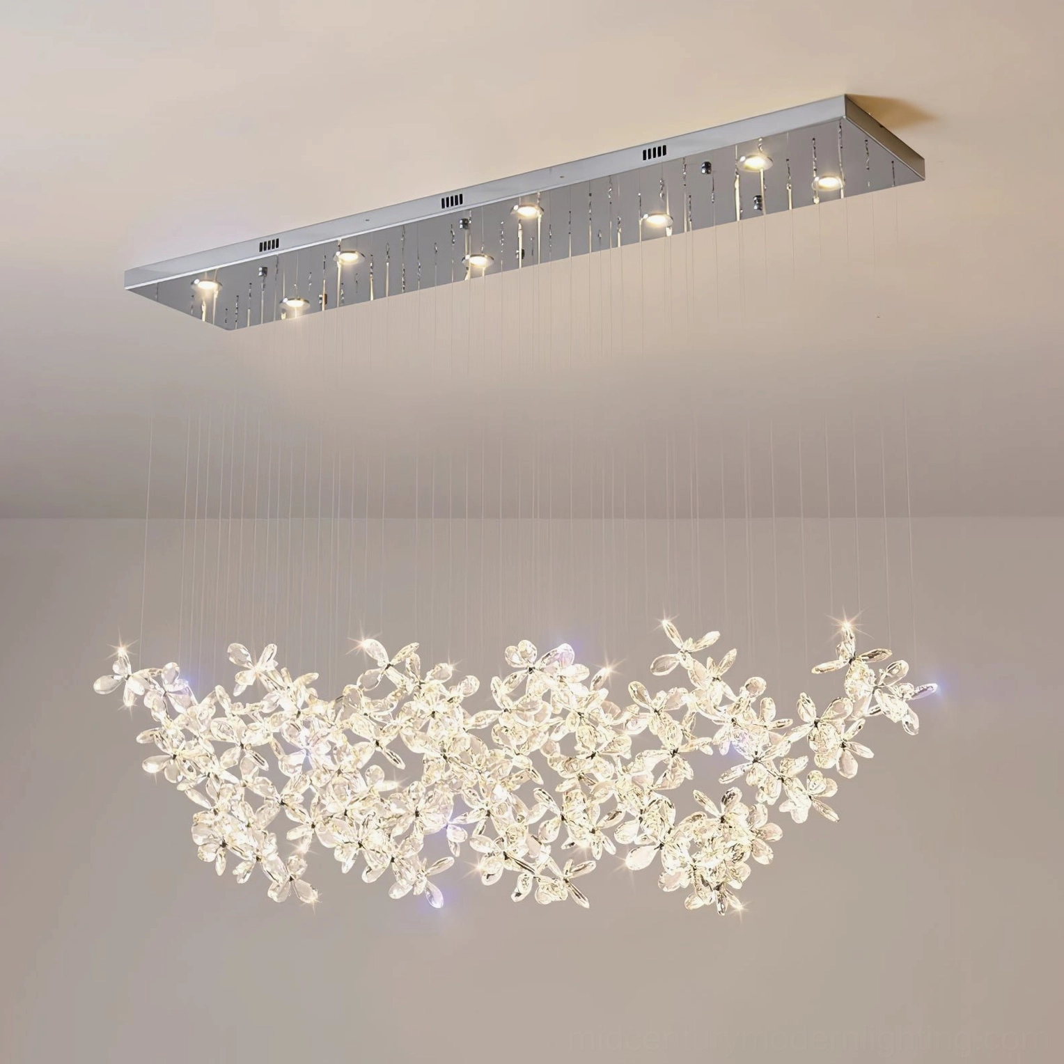 Crystal butterfly chandelier with silver stainless steel ceiling base and thin hanging wires, close detail of metal canopy and suspension system