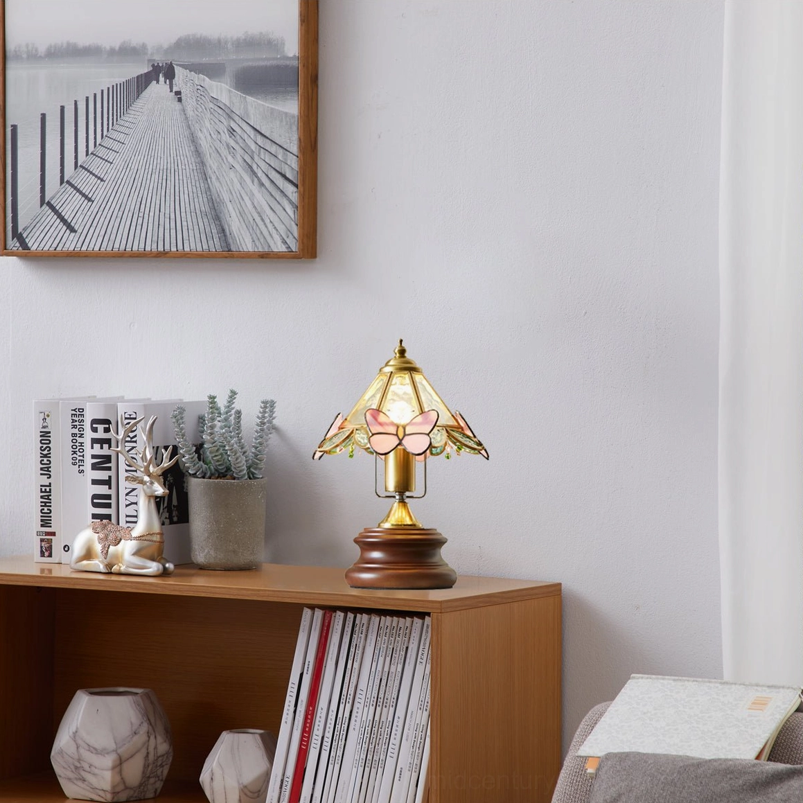 Butterfly table lamp with full shade illuminated showing glass butterfly pattern and warm light distribution