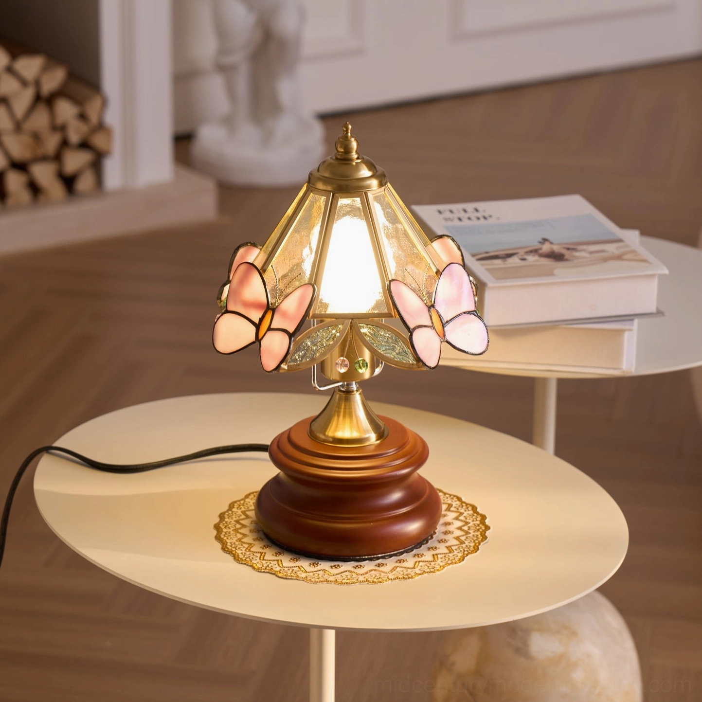 Mid-century modern butterfly table lamp with two pairs of pink butterfly decorations on stacked books side table
