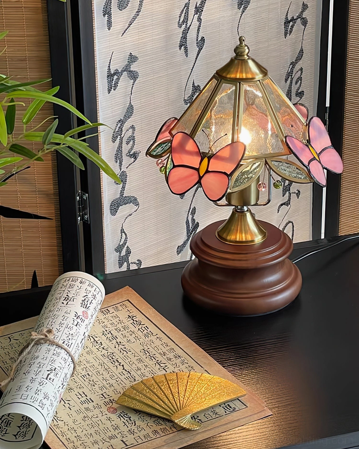 Jenny Butterfly lamp with stained glass shade positioned on nightstand, warm interior lighting demonstration