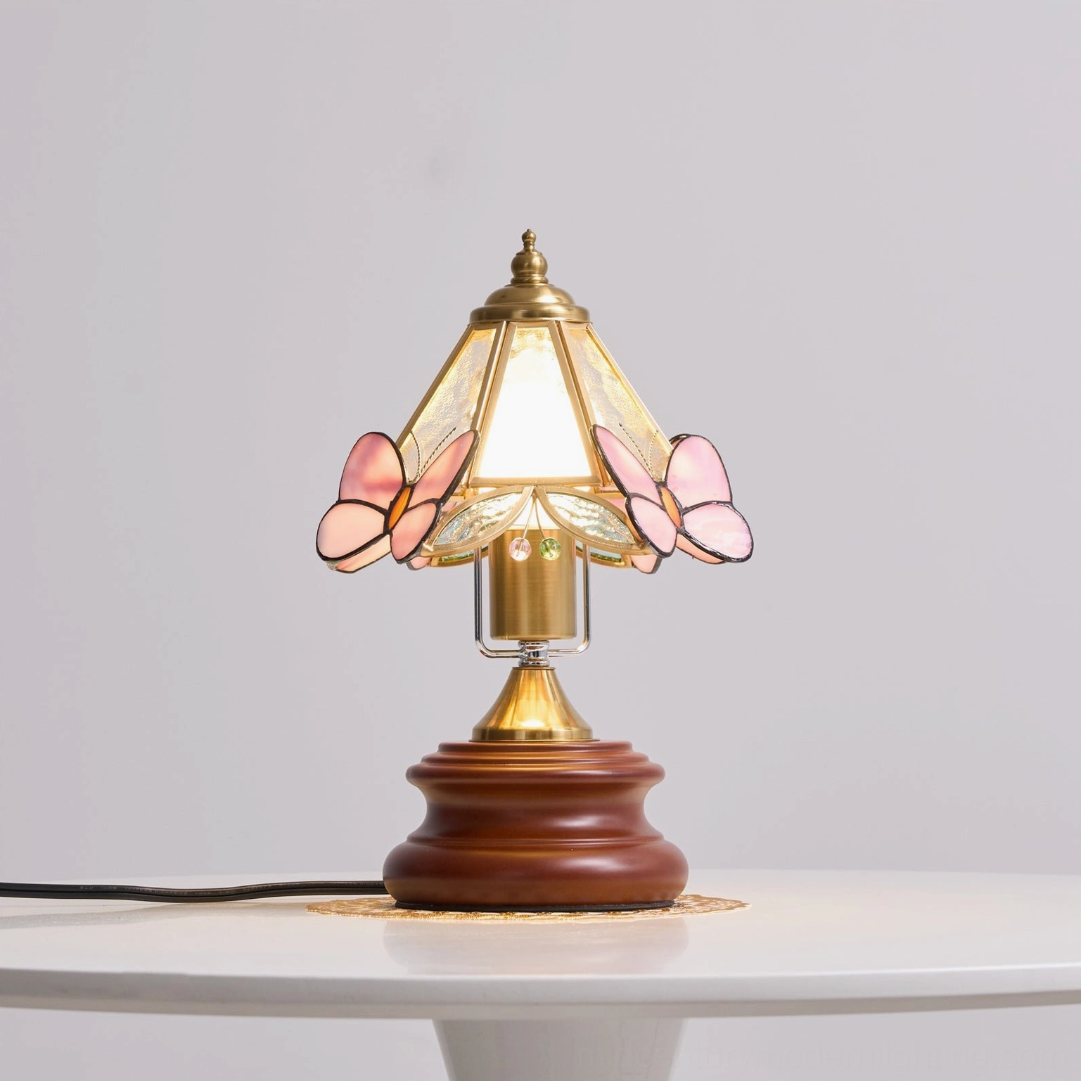 Jenny Butterfly lamp shade detail showing intricate pink butterfly stained glass pattern and light diffusion