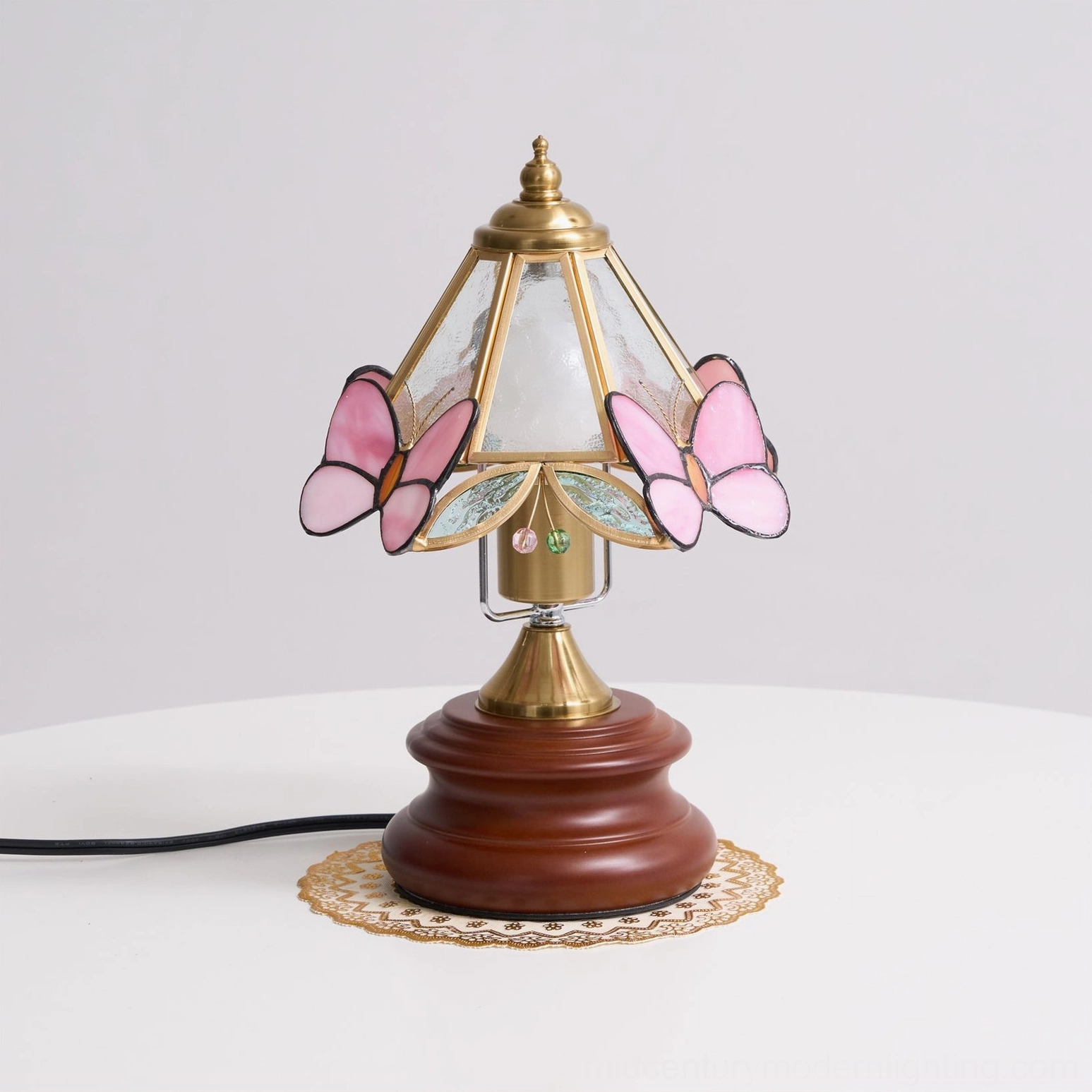 Butterfly table lamp showcasing detailed stained glass construction and brass hardware on mid-century modern nightstand