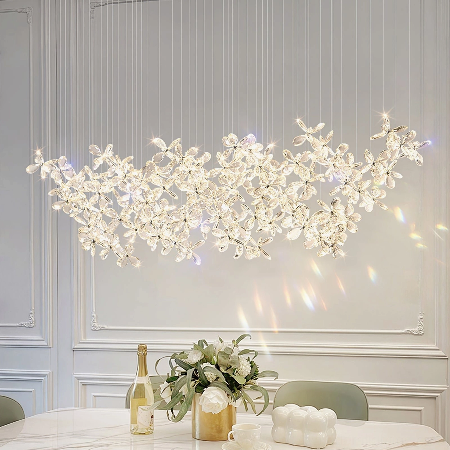 Crystal butterfly chandelier side view casting light refractions on dining table, luxury pendant design with faceted crystal flowers, warm ambient glow