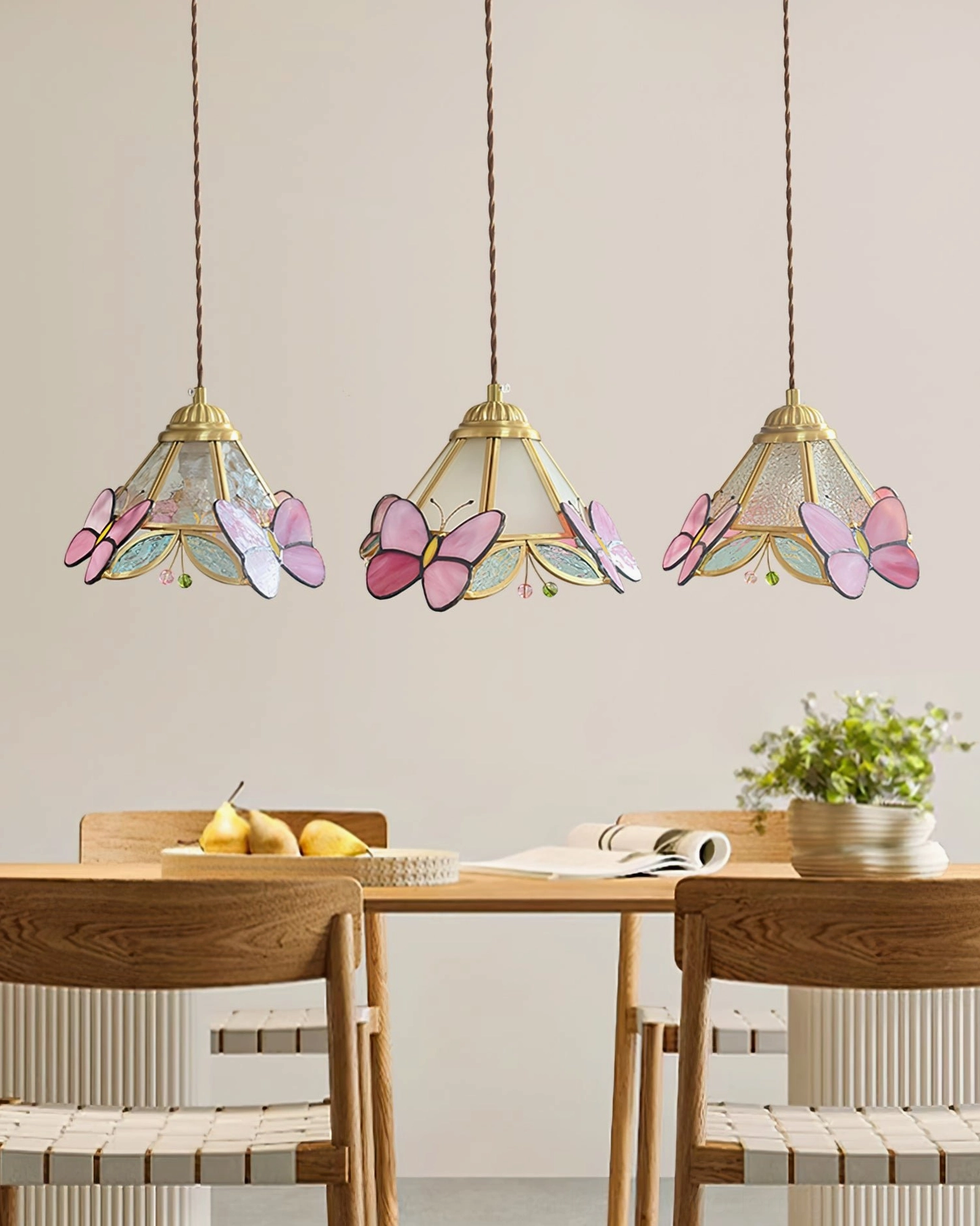 Set of Three Butterfly Pendant Lights Over Wooden Dining Table in Warm Dining Room